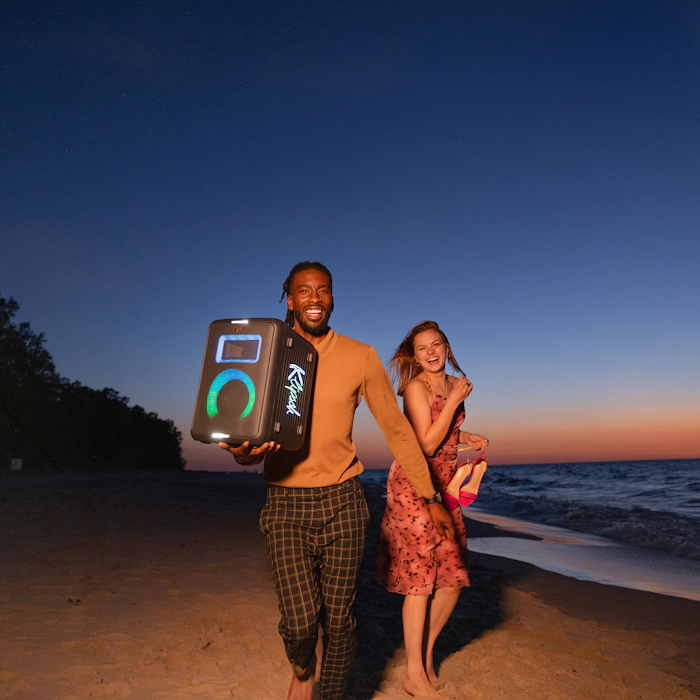 Klipsch Party Speakers Vibe friends running on the beach at sunset with party speaker playing music2 2000x2000
